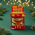 Burger toy without hand on evergreen Christmas background